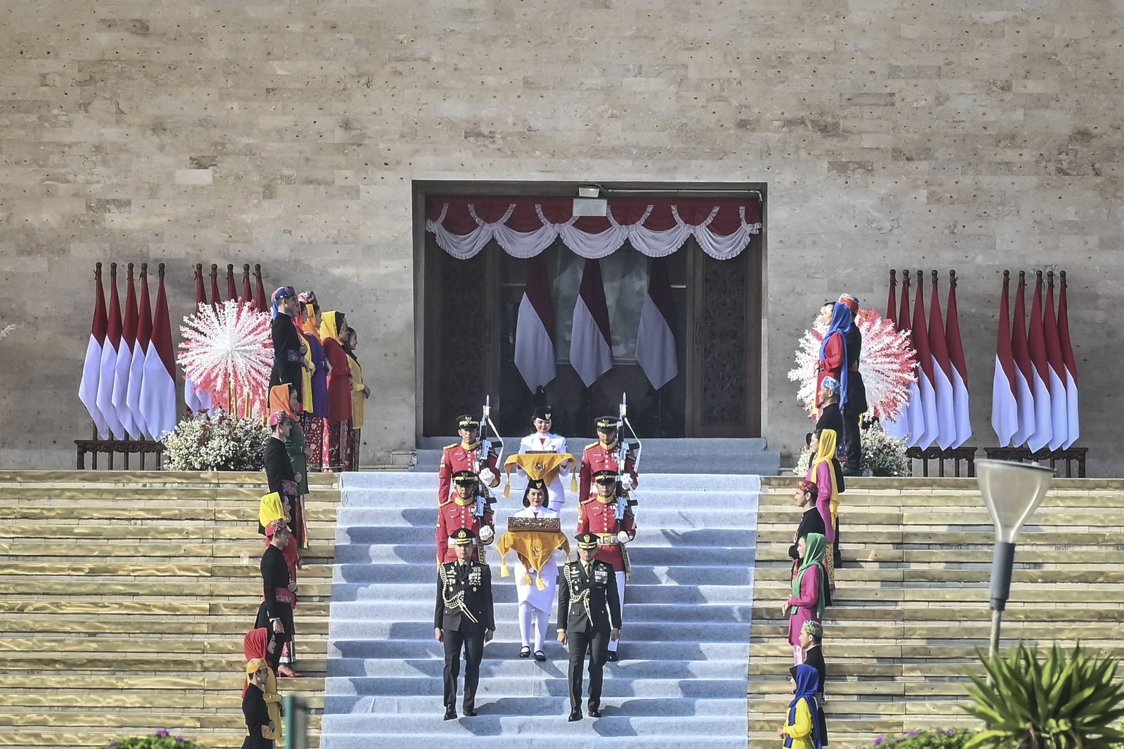 Tim Purna Paskibraka 2023 Kachina Ozora (tengah depan) membawa duplikat bendera Merah Putih sementara rekannya Keyla Azzahra Purnama (tengah belakang) membawa naskah teks proklamasi berjalan menuju kendaraan taktis maung dalam acara kirab bendera Merah Putih dan naskah teks proklamasi menuju Ibu Kota Nusantara (IKN) di kawasan Monumen Nasional (Monas), Jakarta, Sabtu (10/8/2024). Kirab tersebut merupakan rangkaian persiapan peringatan HUT Ke-79 Kemerdekaan RI yang akan digelar di IKN, Penajam Paser Utara, Kalimantan Timur. ANTARA FOTO/Aprillio Akbar/nz